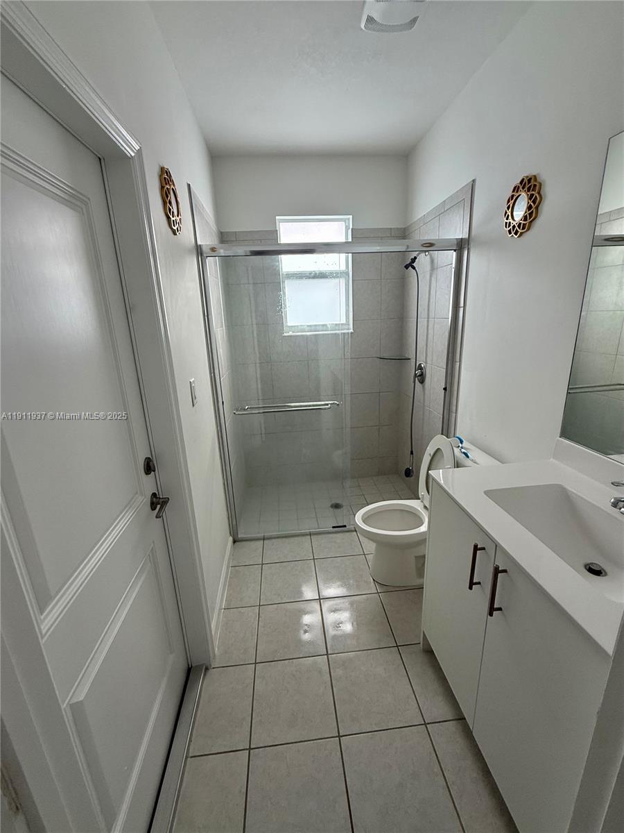 16910 Southwest 288th Street Homestead, FL 33030 - Photo 11 of 15 a bathroom with a sink a toilet and shower