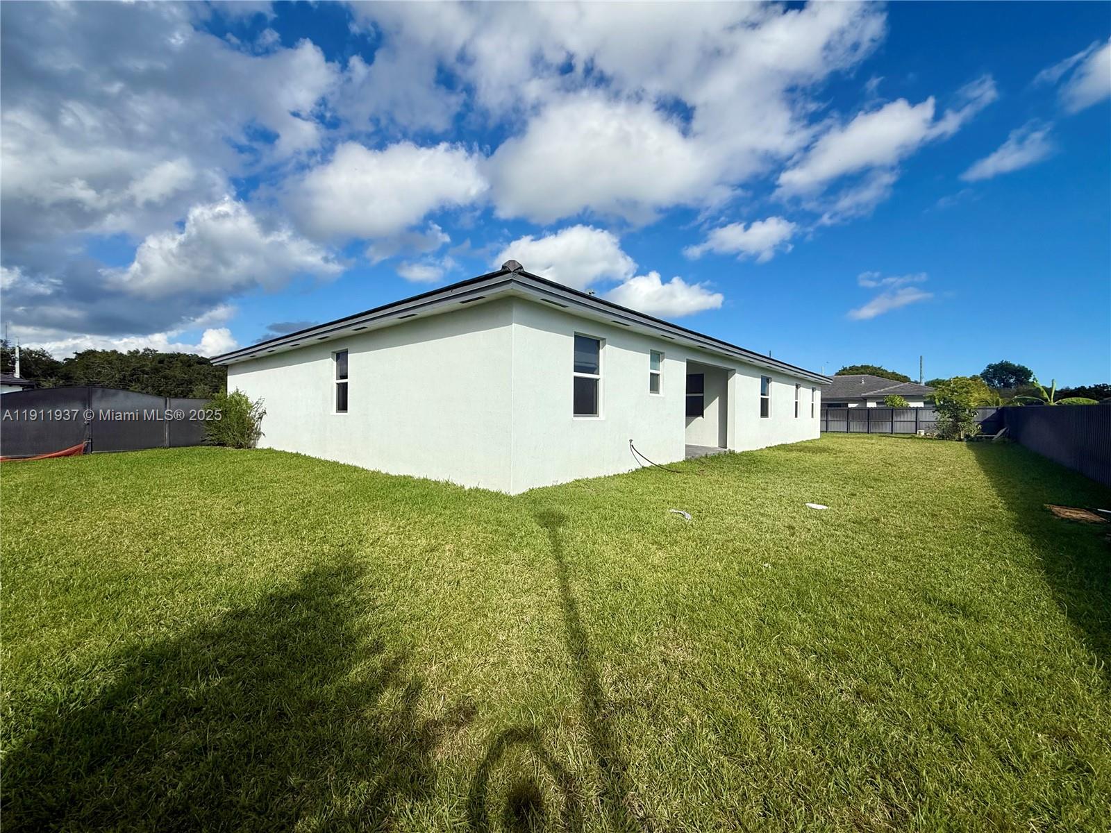 16910 Southwest 288th Street Homestead, FL 33030 - Photo 13 of 15 a view of a backyard with plants and a big yard