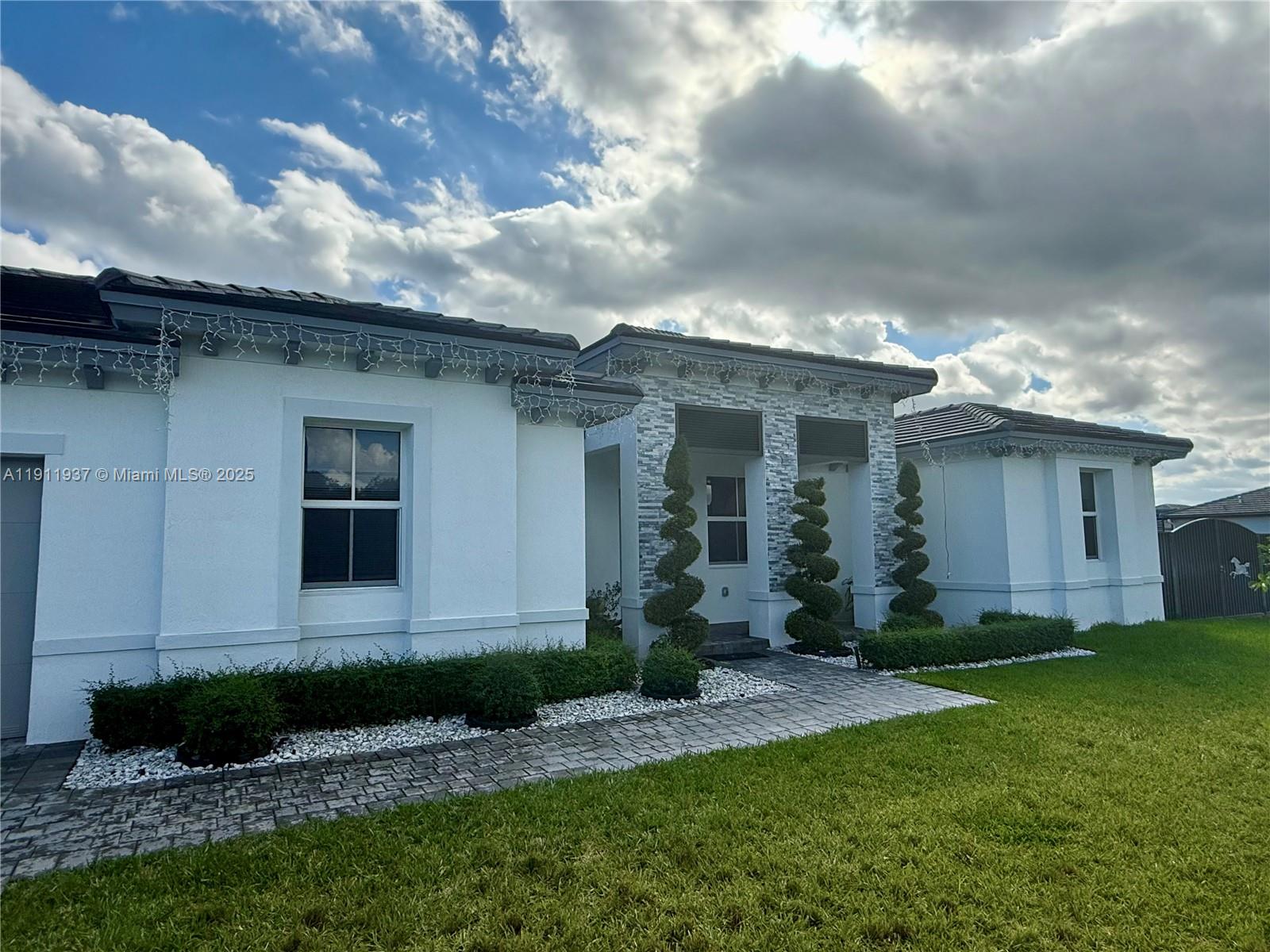 16910 Southwest 288th Street Homestead, FL 33030 - Photo 15 of 15 a front view of a house with a yard and garage