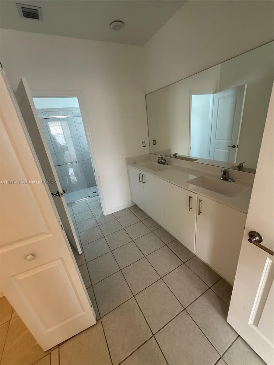 16910 Southwest 288th Street Homestead, FL 33030 - Photo 6 of 15 a bathroom with a sink a toilet and a mirror