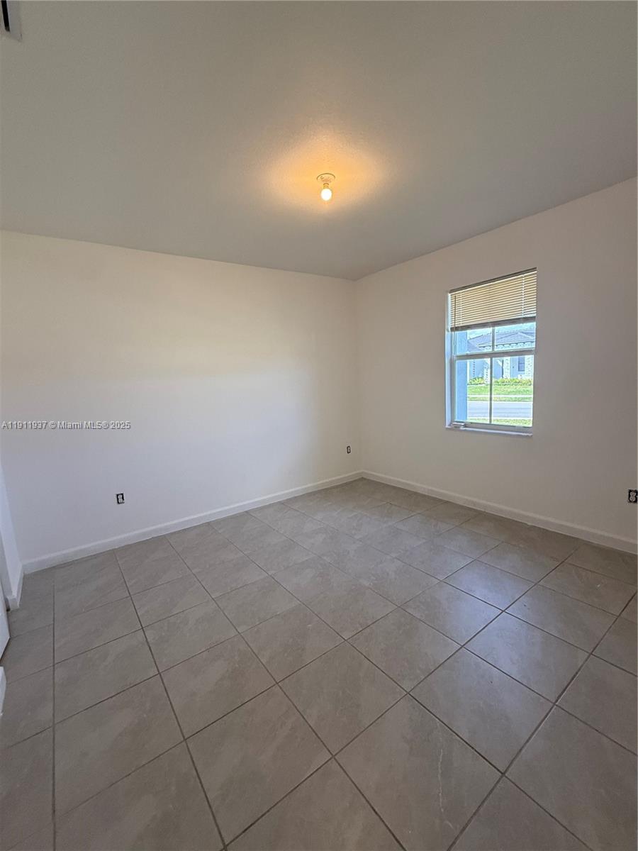16910 Southwest 288th Street Homestead, FL 33030 - Photo 8 of 15 an empty room with a empty space and a window