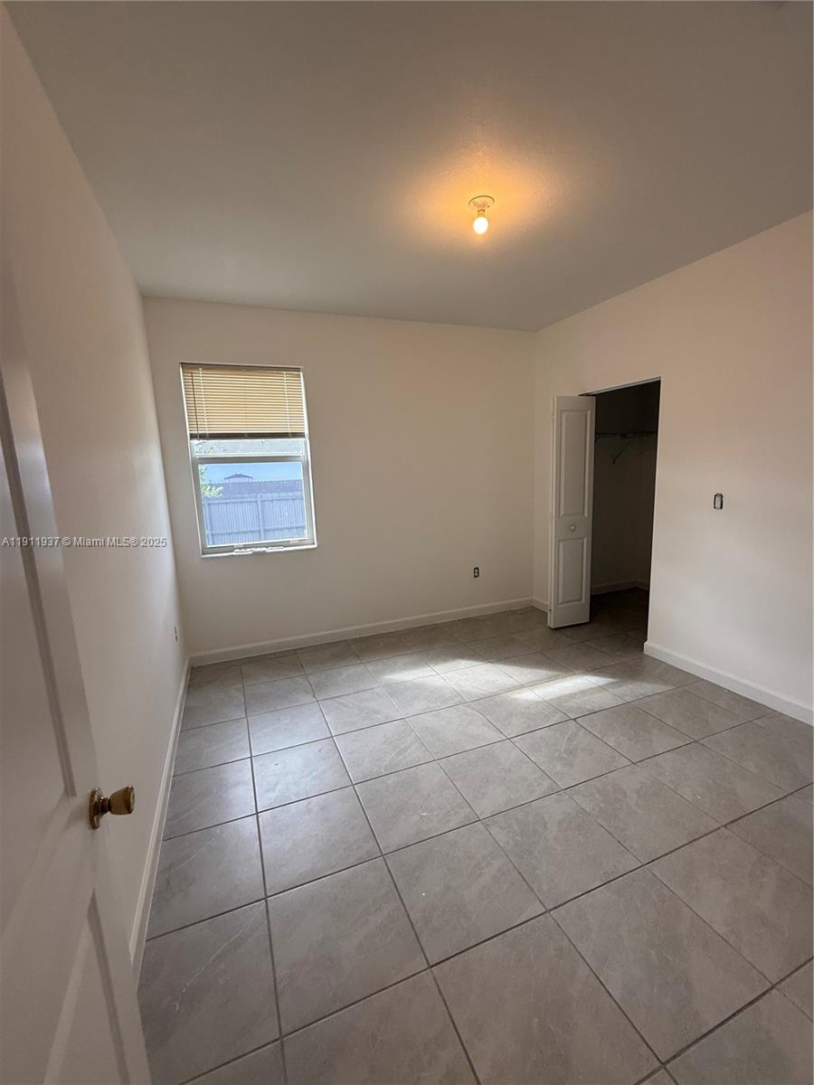 16910 Southwest 288th Street Homestead, FL 33030 - Photo 9 of 15 a view of an empty room with a window