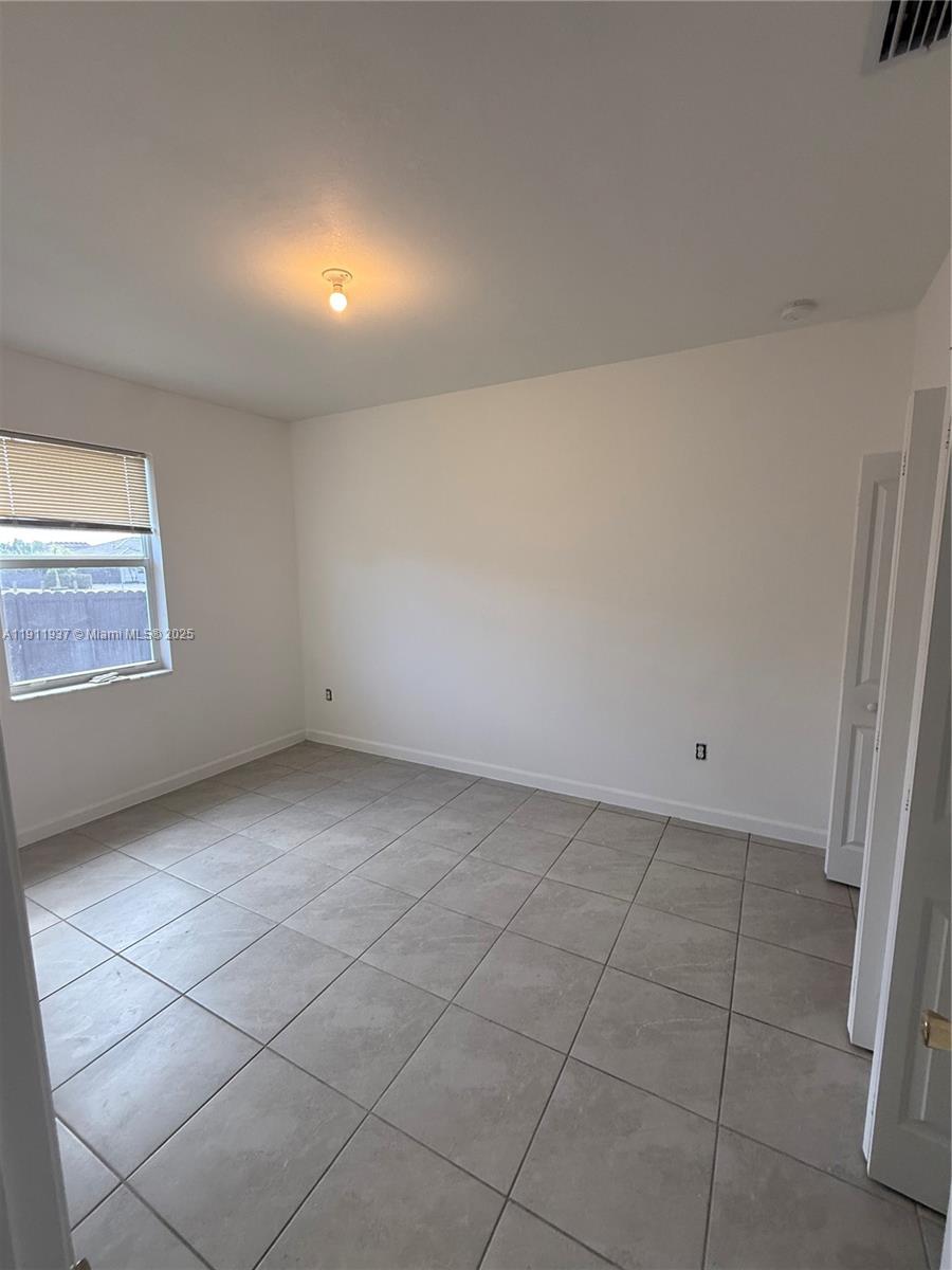 16910 Southwest 288th Street Homestead, FL 33030 - Photo 10 of 15 a view of an empty room and window