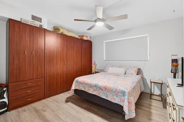 a bedroom with a bed and a mirror