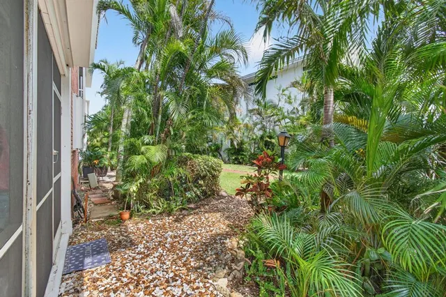 a backyard of a house with lots of potted plants