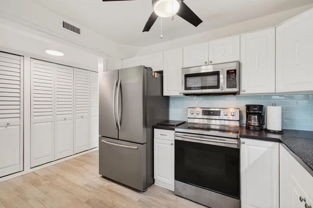 a kitchen with stainless steel appliances a stove microwave and a refrigerator