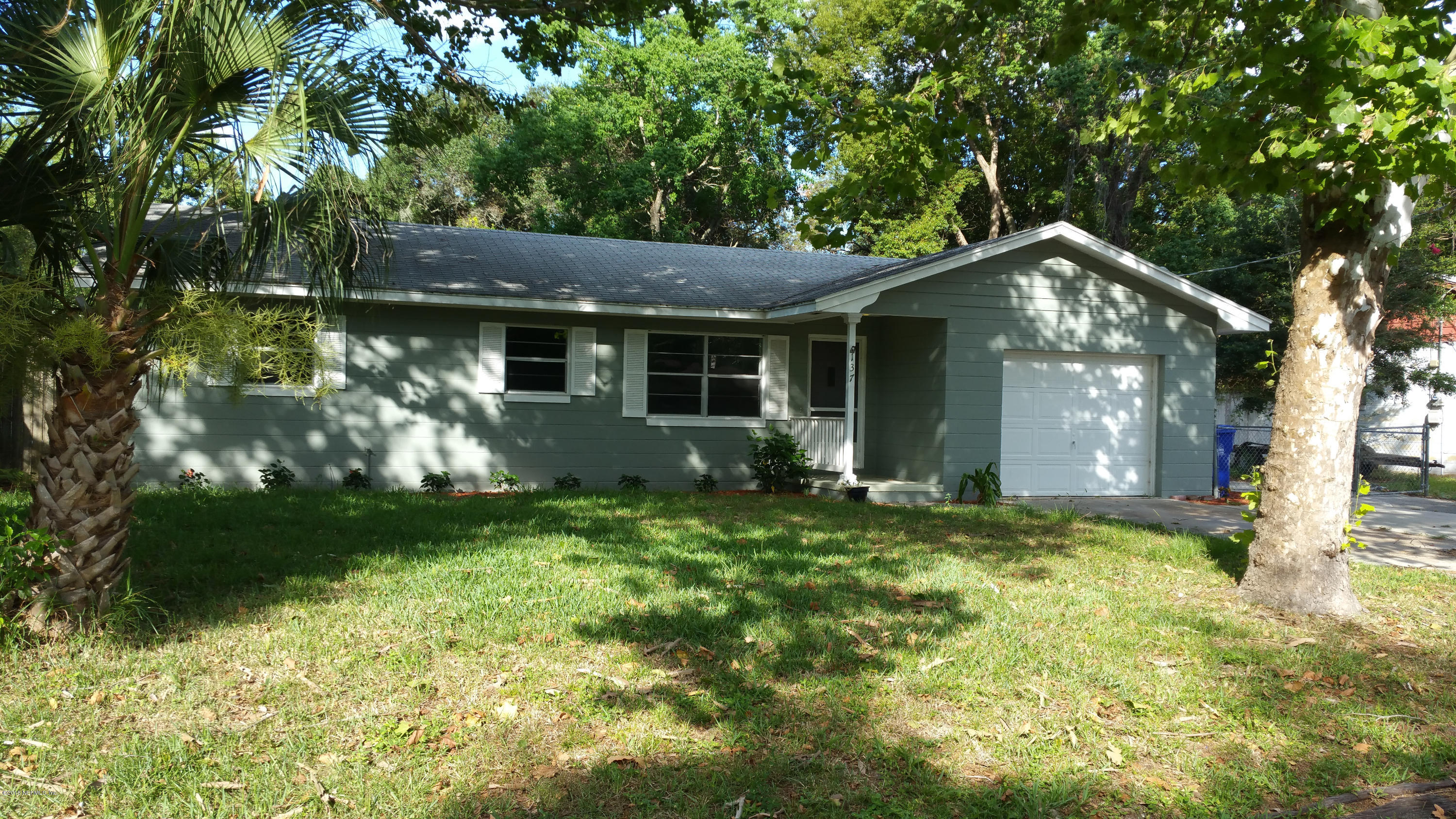 137 Argonaut Road St. Augustine, FL 32086 - Photo 1 of 14 a house is sitting in middle of the green field