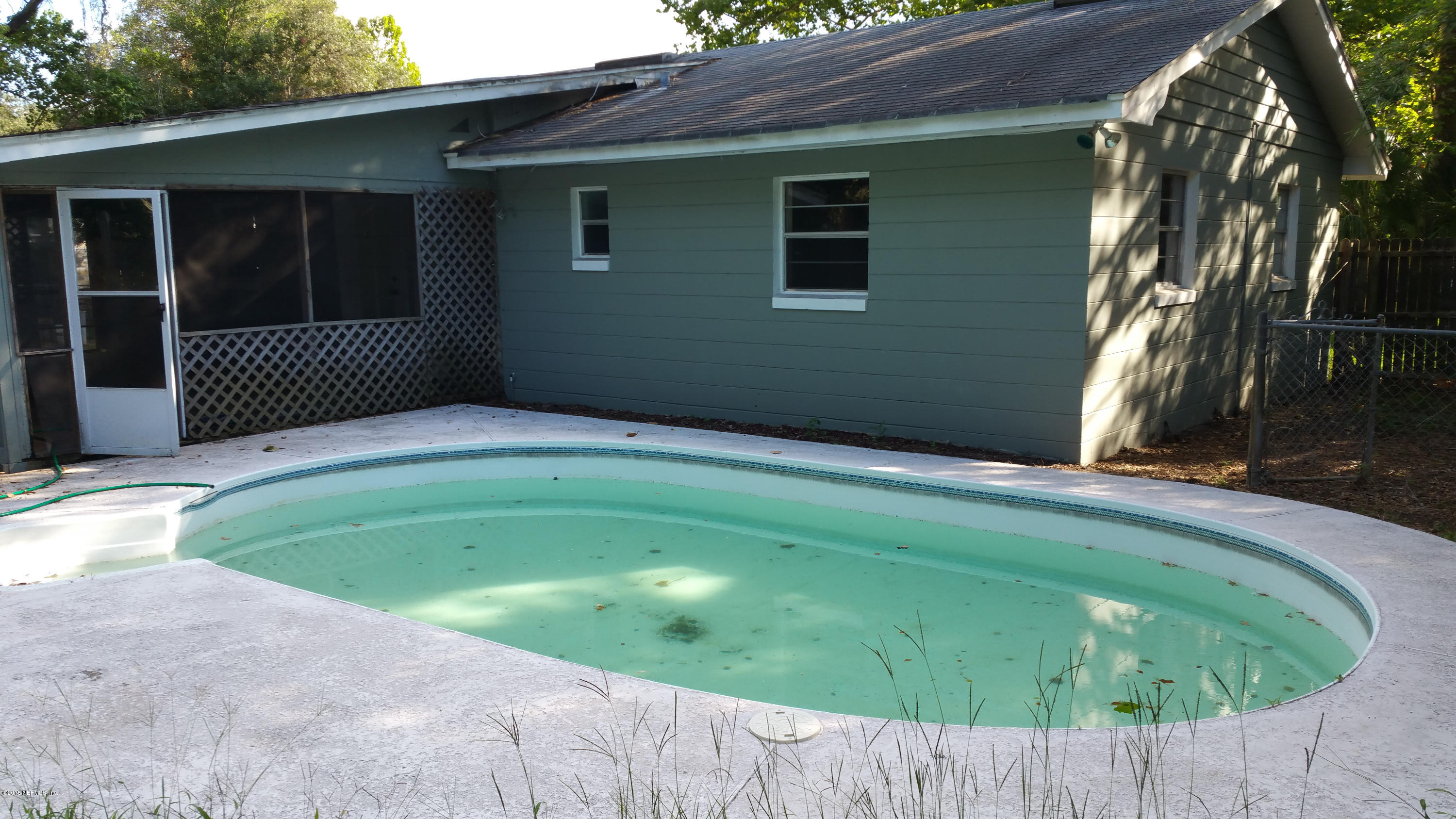 137 Argonaut Road St. Augustine, FL 32086 - Photo 11 of 14 a backyard of a house with plants and wooden fence