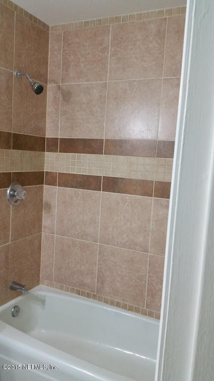 137 Argonaut Road St. Augustine, FL 32086 - Photo 7 of 14 a bathroom with a shower and a bathtub
