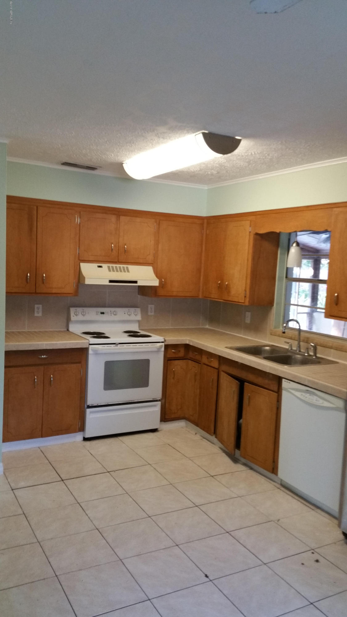 137 Argonaut Road St. Augustine, FL 32086 - Photo 9 of 14 a kitchen with stainless steel appliances granite countertop a stove a sink and a refrigerator