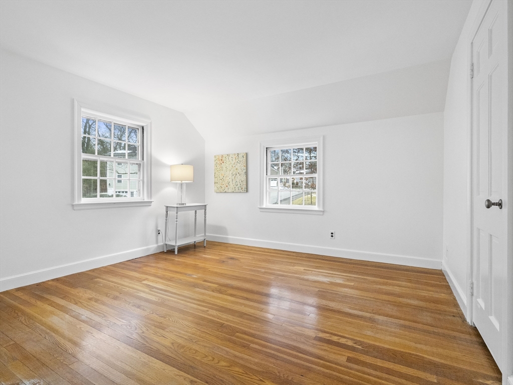 14 Ivy Road Wellesley, MA 02482 - Photo 16 of 22 a view of an empty room with wooden floor and a window