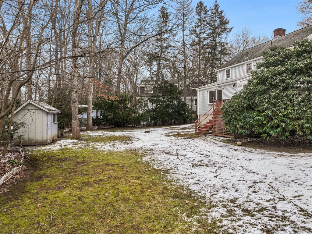 14 Ivy Road Wellesley, MA 02482 - Photo 20 of 22 a backyard of a house with large trees and covered with tall trees