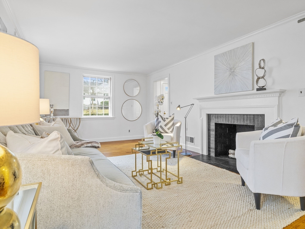 14 Ivy Road Wellesley, MA 02482 - Photo 4 of 22 a living room with furniture a fireplace and a large window