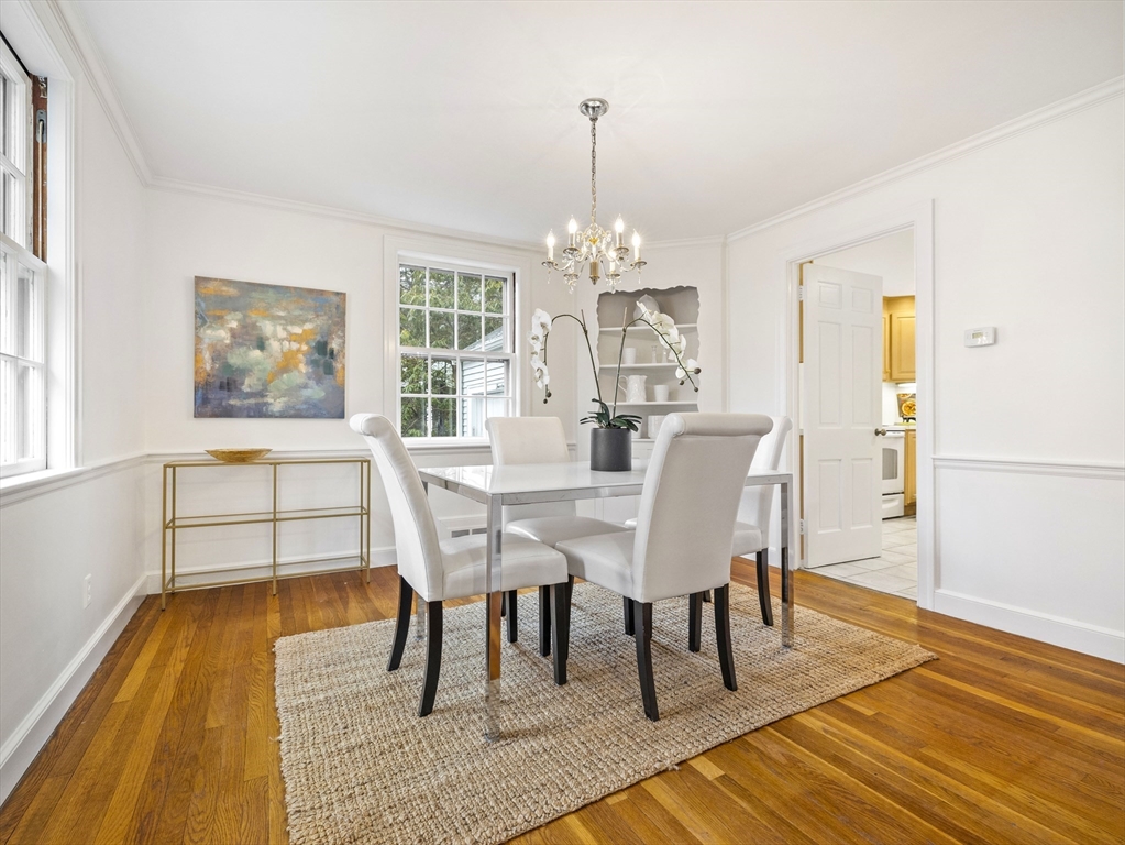 14 Ivy Road Wellesley, MA 02482 - Photo 6 of 22 a dining room with wooden floor a chandelier a wooden table and chairs
