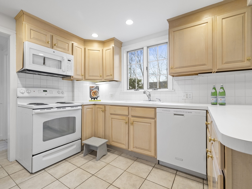 14 Ivy Road Wellesley, MA 02482 - Photo 9 of 22 a kitchen with white cabinets stainless steel appliances and sink