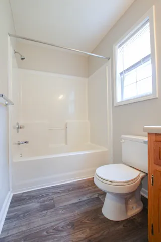 a bathroom with a toilet and a bath tub
