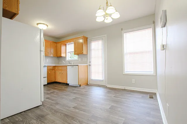 a view of a kitchen with a sink dishwasher and wooden floor