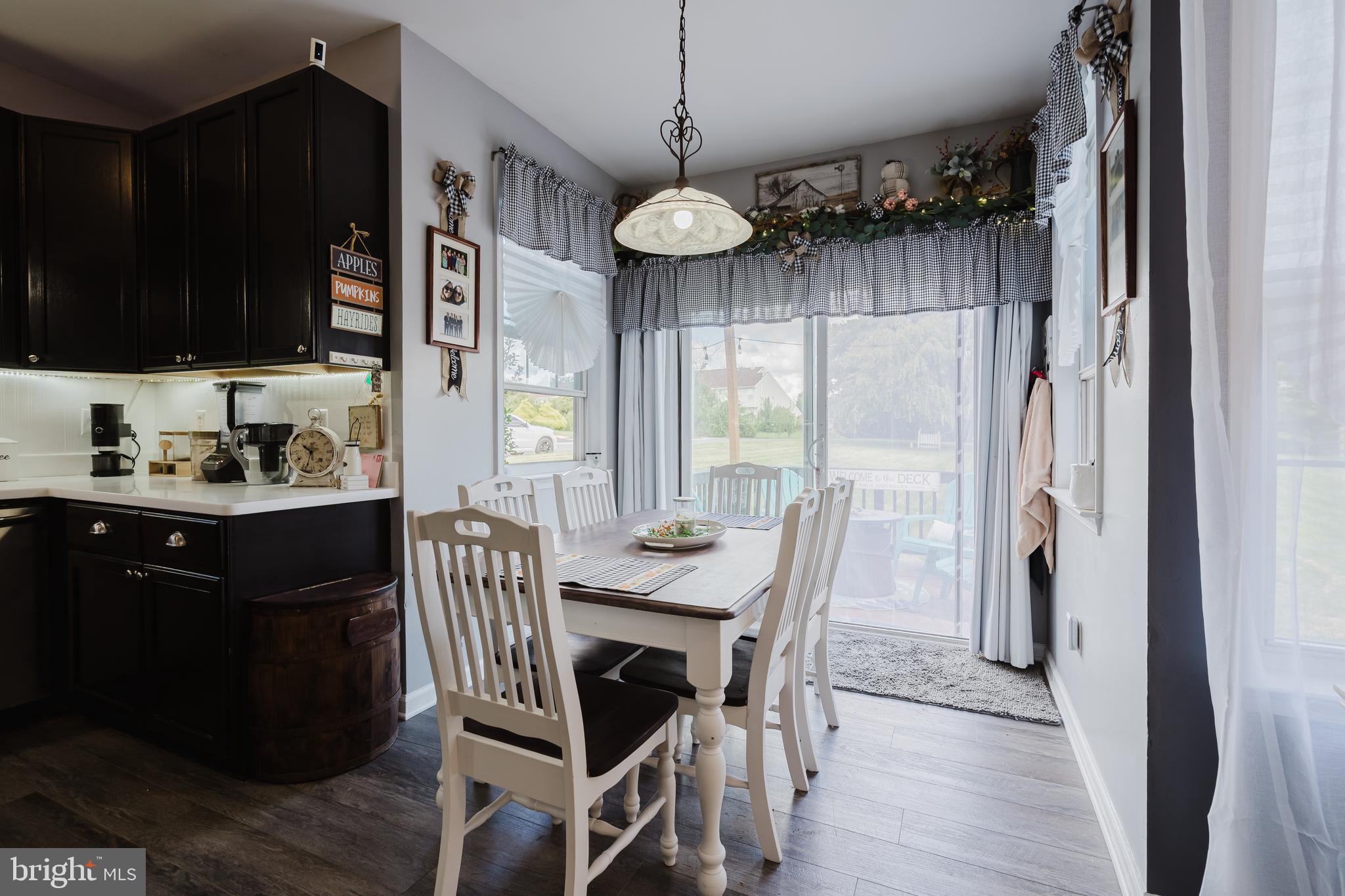 1 Bohemia Road Bear, DE 19701 - Photo 15 of 66 a view of a dining room with furniture window and wooden floor
