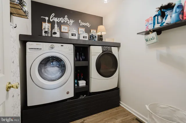 a view of a house with a big yard plants and large trees
