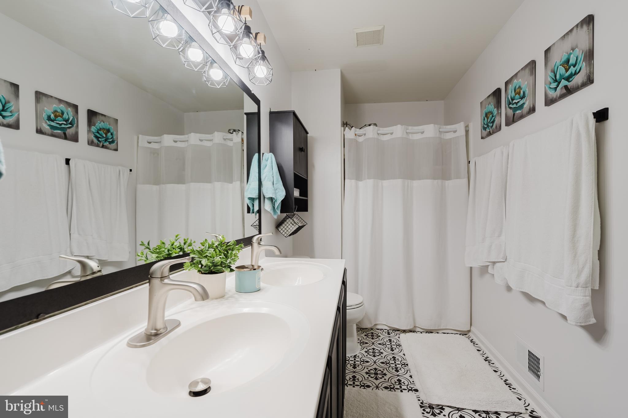 1 Bohemia Road Bear, DE 19701 - Photo 41 of 66 a bathroom with a sink a mirror and a shower