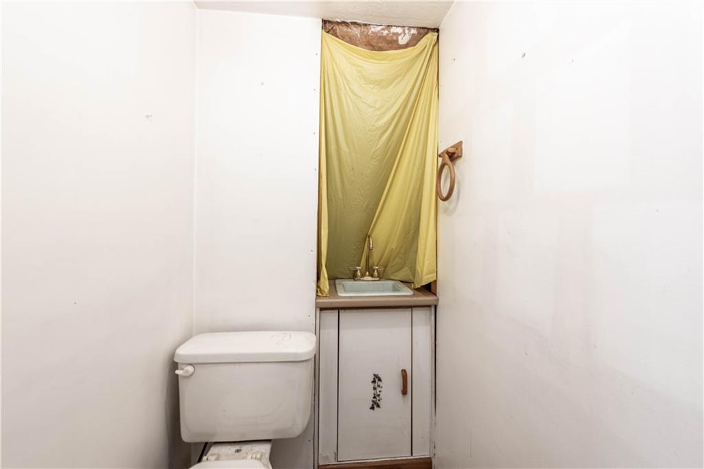 320 Deerfield Road Washington, PA 15301 - Photo 27 of 32 The half bath in the party room area. She needs some love but again, they used this space for storage.