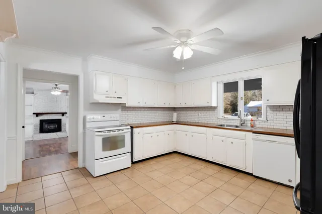 a kitchen with granite countertop cabinets a sink and appliances