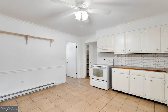 a kitchen with white cabinets and white appliances
