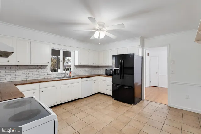 a large kitchen with cabinets and stainless steel appliances