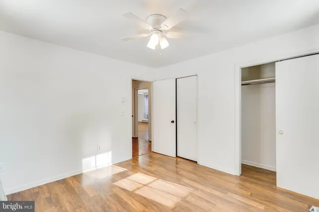 a view of an empty room with wooden floor