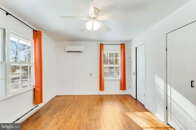 wooden floor in an empty room with a window