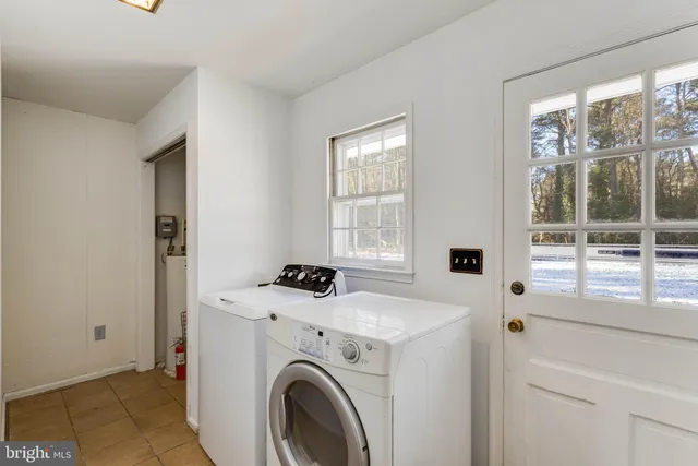 a view of washer and dryer with kitchen in the background