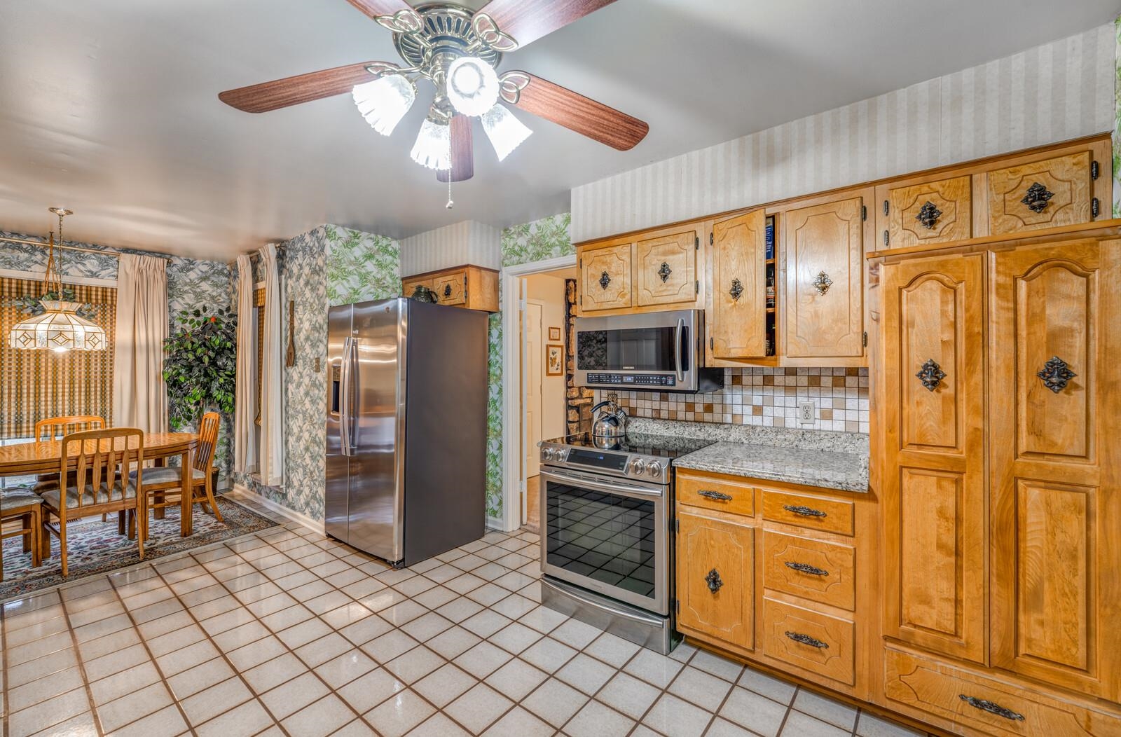 9715 Deadfall Road Brighton, TN 38011 - Photo 12 of 25 a kitchen with stainless steel appliances granite countertop a refrigerator and a stove top oven