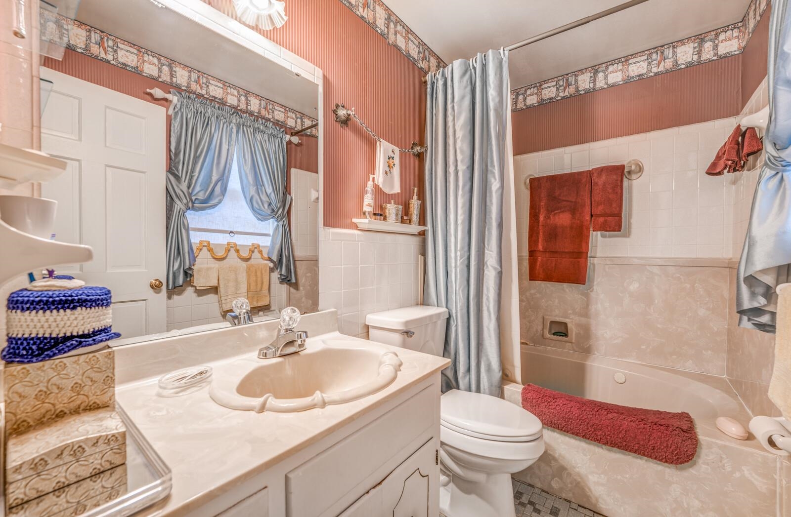 9715 Deadfall Road Brighton, TN 38011 - Photo 16 of 25 Full bathroom with shower / bath combination with curtain, vanity, toilet, and tile walls