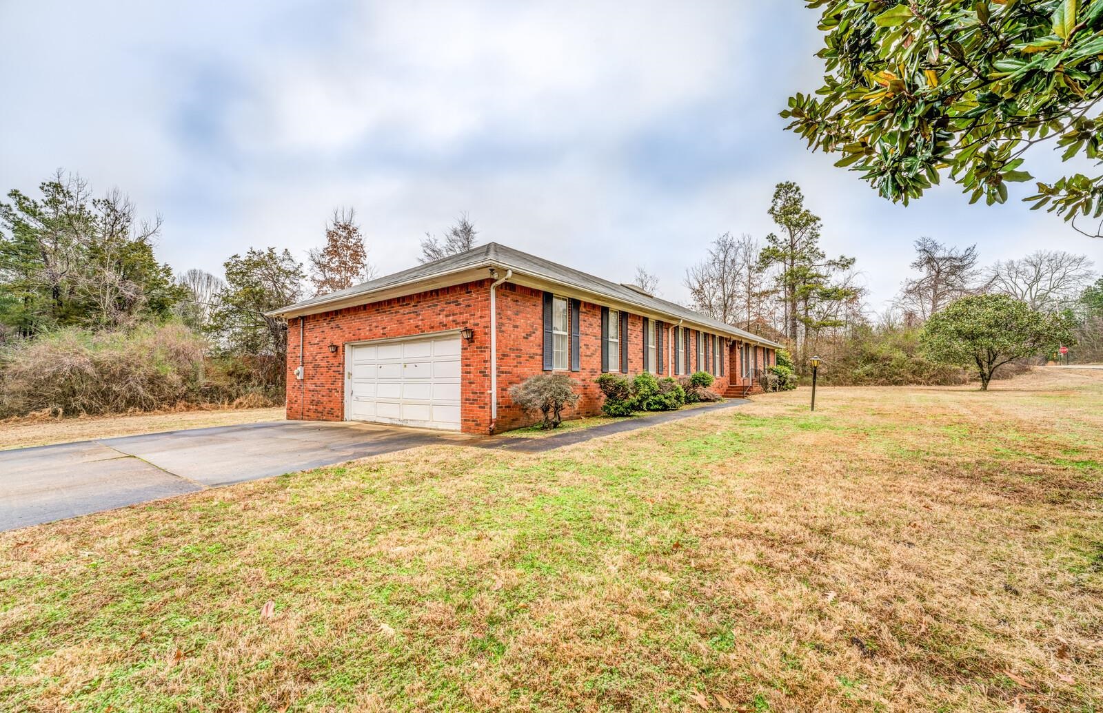 9715 Deadfall Road Brighton, TN 38011 - Photo 2 of 25 View of home's exterior with a garage and a lawn