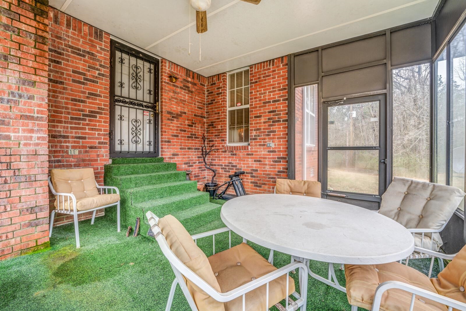 9715 Deadfall Road Brighton, TN 38011 - Photo 21 of 25 a backyard of a house with table and chairs