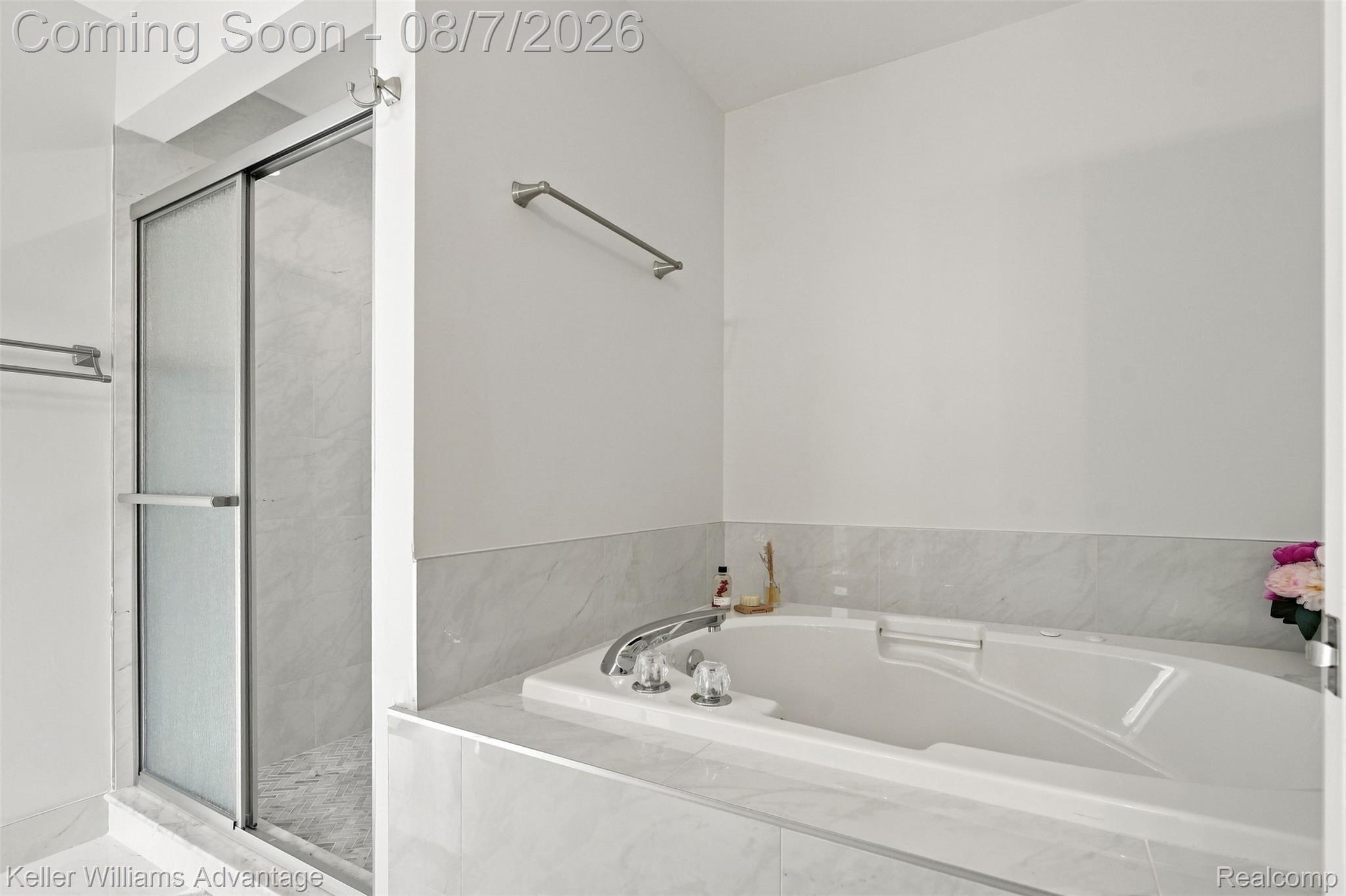 5325 Simpson Lake Road West Bloomfield, MI 48323 - Photo 27 of 43 Built-in soaking tub with deck-mounted faucet, surrounded by light-toned tile