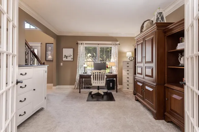 a living room with furniture a window and gym equipment