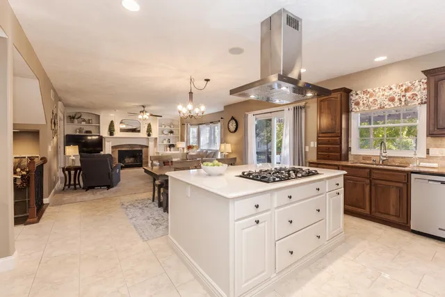 a kitchen with stainless steel appliances kitchen island granite countertop a stove oven and a refrigerator