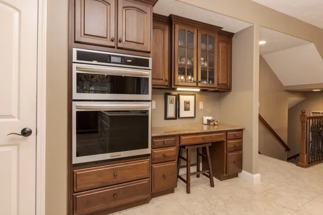 a kitchen with stainless steel appliances granite countertop a stove microwave and cabinets