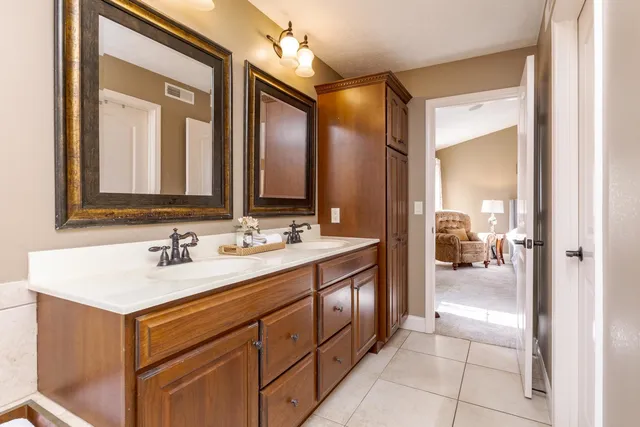 a bathroom with a tub a sink and a window
