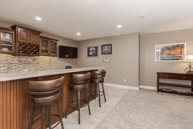 a view of empty room with kitchen
