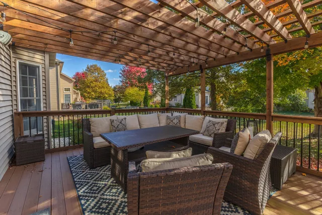 a view of a patio with table and chairs potted plants and a palm tree