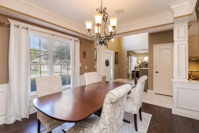 a view of a dining room with furniture wooden floor and chandelier