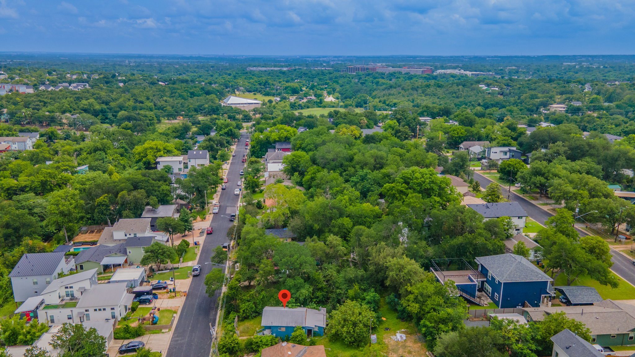1408 Luna Street Austin, TX 78721 - Photo 4 of 5 Aerial view showcasing a lush, tree-lined neighborhood with well-maintained streets and verdant landscapes.