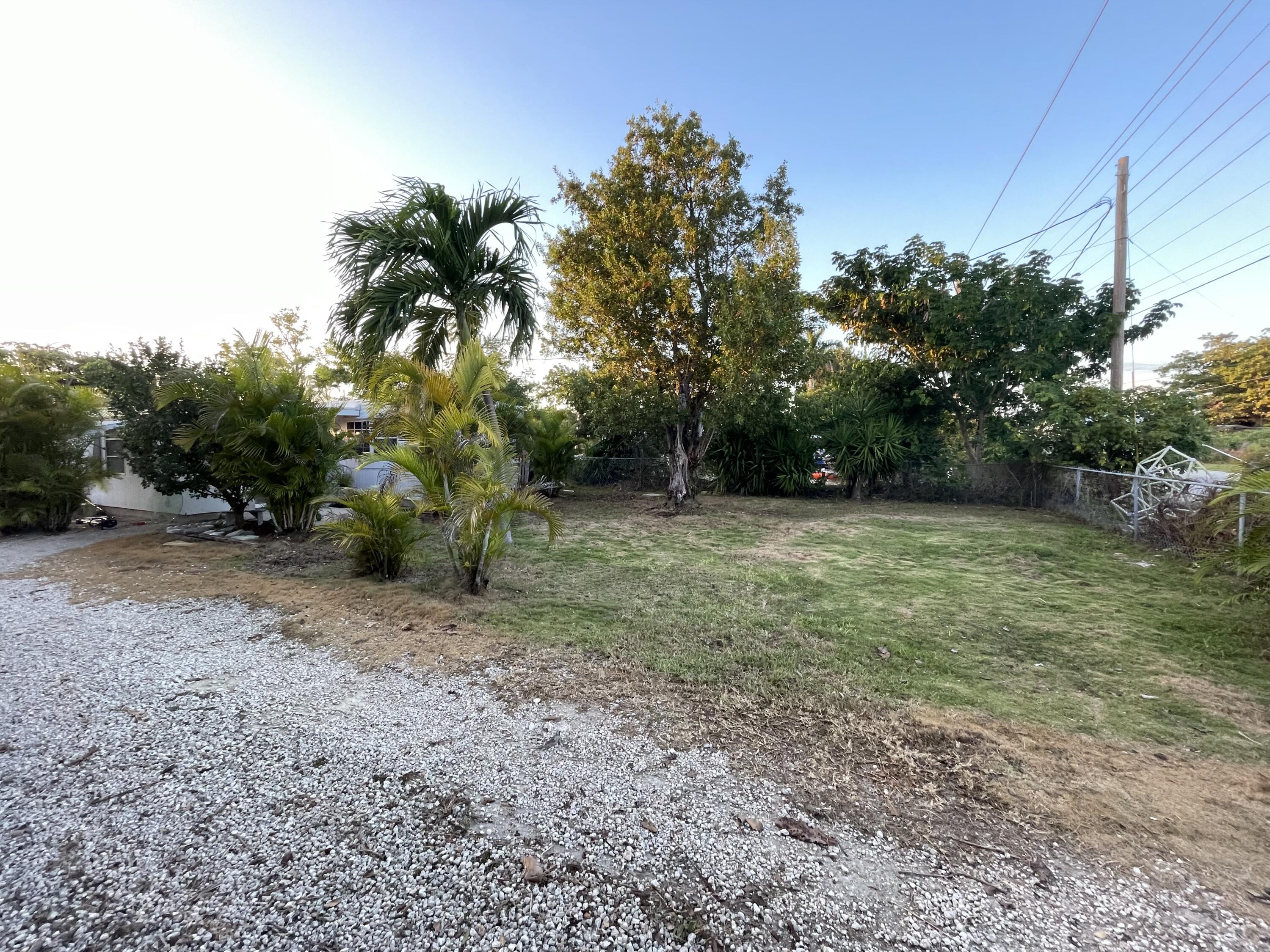 156 County Road Big Pine Key, FL 33043 - Photo 5 of 15 a view of a field with trees in the background