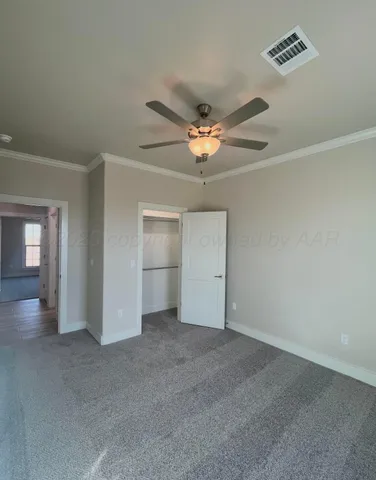a view of an empty room with a ceiling fan