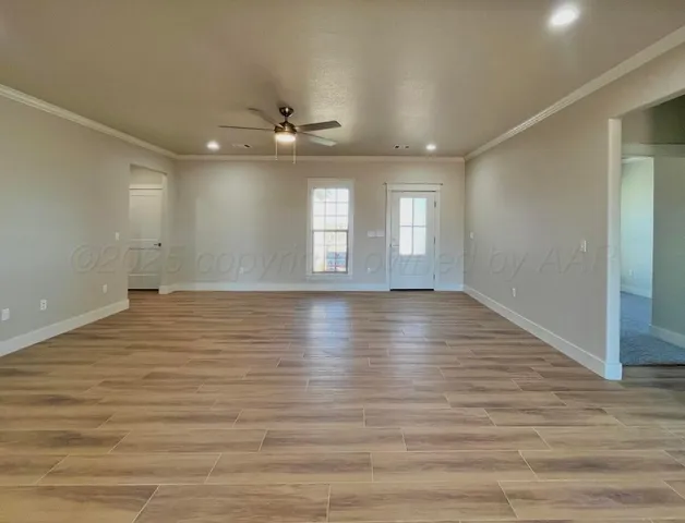 a large kitchen with cabinets and wooden floor
