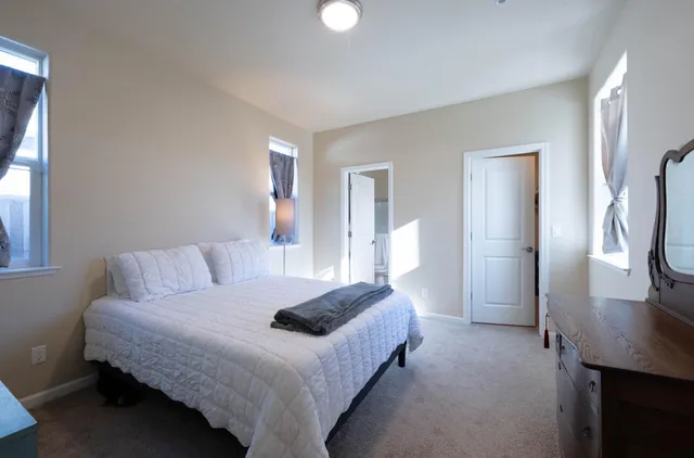 a bedroom with a bed and a window