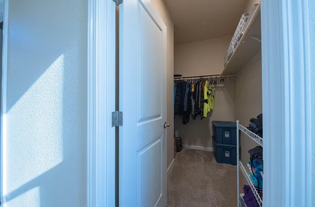 a bedroom with a large bed and a dresser