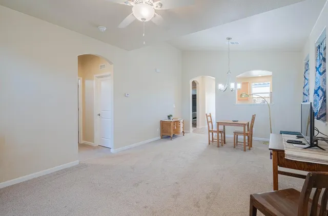 a view of a dining room with furniture and chandelier